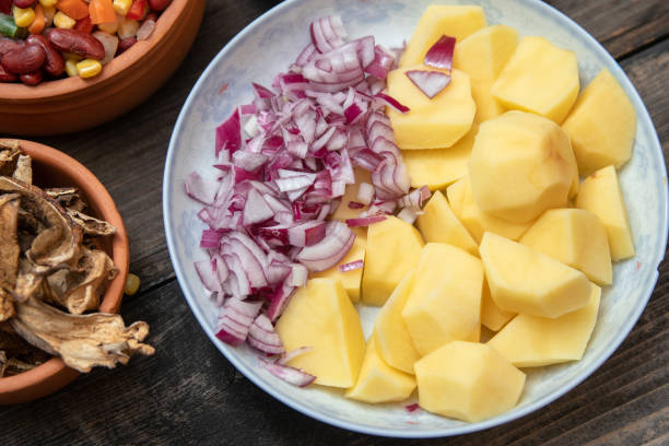 istock Sliced potato and onion on ceramic plate 1132106223