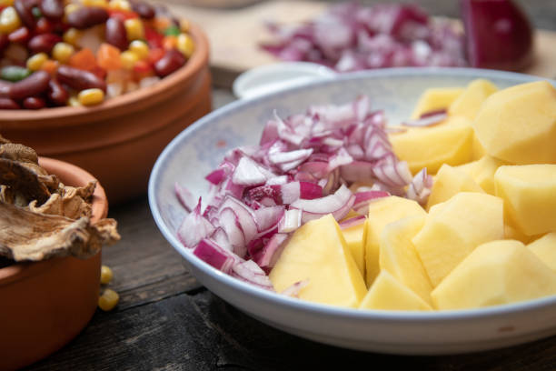 istock Sliced potato and onion on ceramic plate 1132106248