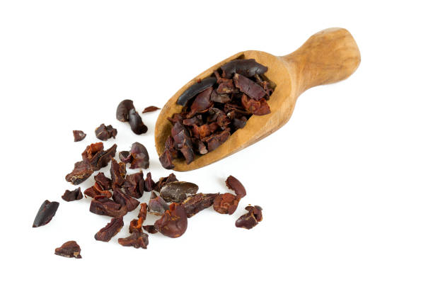 istock cocoa nibs in a wooden scoop isolated on white 1132106737