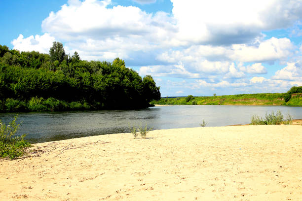 istock Beautiful summer landscape, sandy beach, river, blue sky and white big clouds. 1132107168