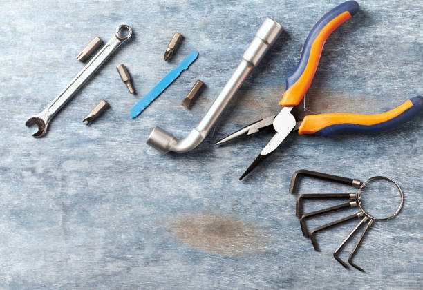 istock Screwdriver, hex keys, socket wrench and bits for a screwdriver on rustic wooden background. Directly Above. copy space. 1132109663
