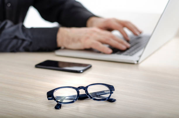 istock Man in black shirt typing on laptop 1132109856