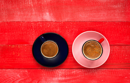 Two coffee espresso cups on wooden table