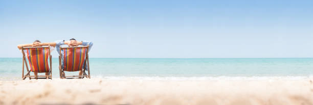 istock Young couple relaxing on chair beach. 1132112848