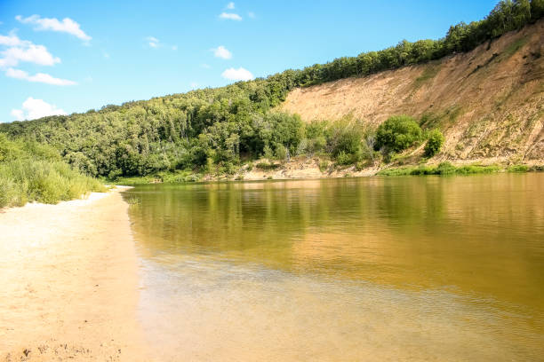 istock Beautiful summer landscape, sandy beach, river, blue sky and white big clouds. 1132113908
