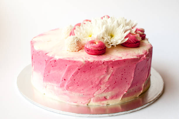 istock Wedding cake with white spring flowers and macaroon on top. 1132113971