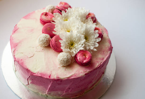 istock Wedding cake with white spring flowers and macaroon on top. 1132113975