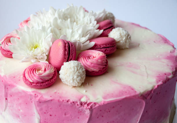 istock Wedding cake with white spring flowers and macaroon on top. 1132114164