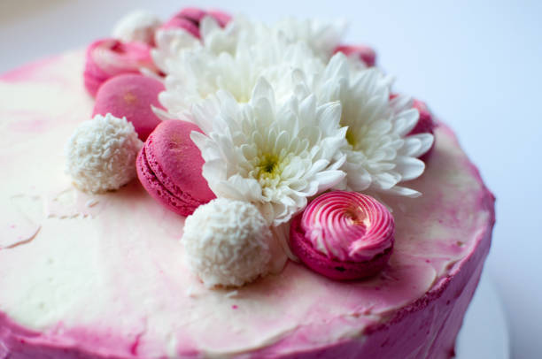 istock Wedding cake with white spring flowers and macaroon on top. 1132114201