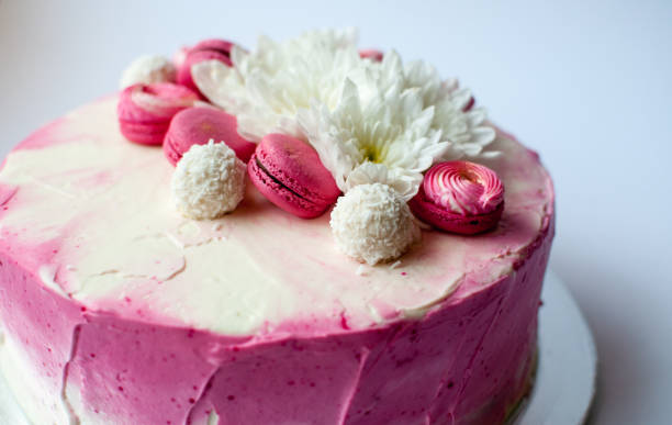 istock Wedding cake with white spring flowers and macaroon on top. 1132114202