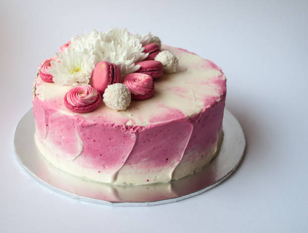 istock Wedding cake with white spring flowers and macaroon on top. 1132114481