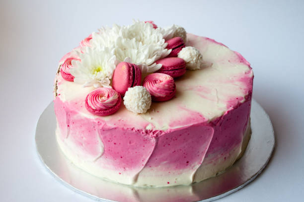 istock Wedding cake with white spring flowers and macaroon on top. 1132115230