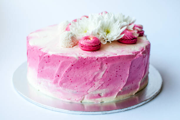istock Wedding cake with white spring flowers and macaroon on top. 1132115256