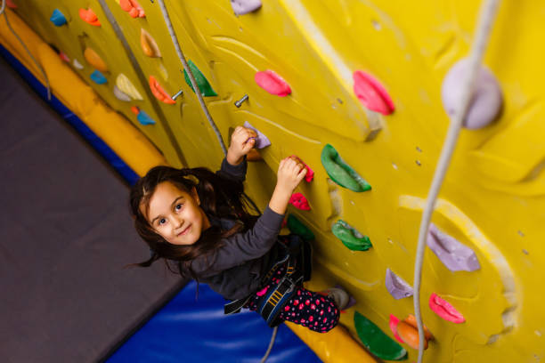 istock Little Girl Climbing Rock Wall 1132115586