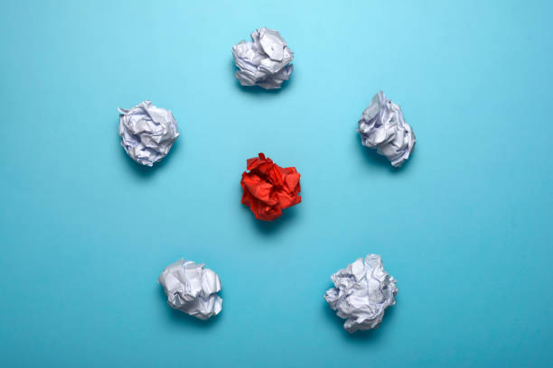 istock Crumpled paper balls on a blue background 1132115740