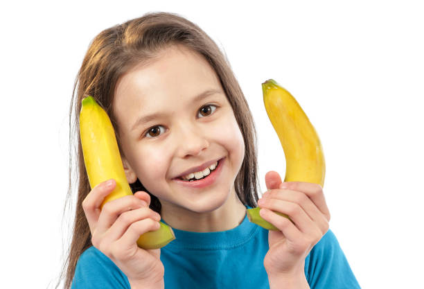 istock Happy smiling child with banana 1132116100