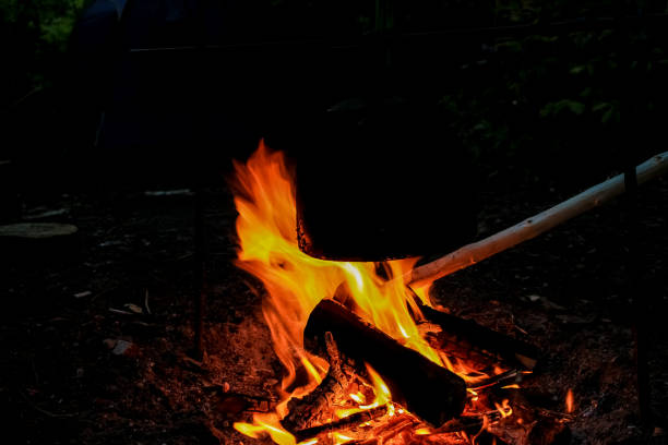 Rest on the nature, a black kettle is heated by water on a fire. Rest on the nature, a black kettle is heated by water on a fire. огонь stock pictures, royalty-free photos & images