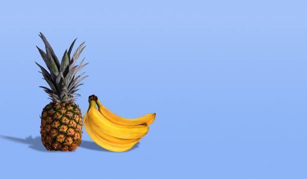 istock Pineapple and banana on blue background with copy space 1132118610