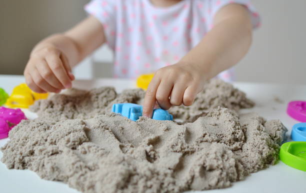 istock Little girl hand playing with kinetic sand 1132120751