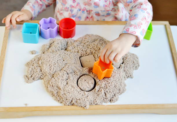 istock Little girl hand playing with kinetic sand 1132120756