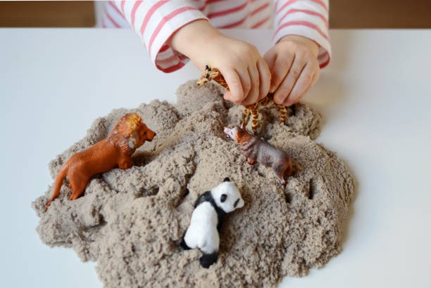 istock Little girl hand playing with kinetic sand 1132120757