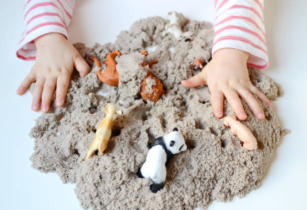 istock Little girl hand playing with kinetic sand 1132120804