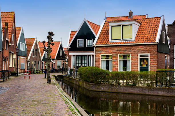 Traditional Volendam houses Traditional houses near canal in Holland town Volendam, Netherlands, in a spring day. ukrainian village stock pictures, royalty-free photos & images