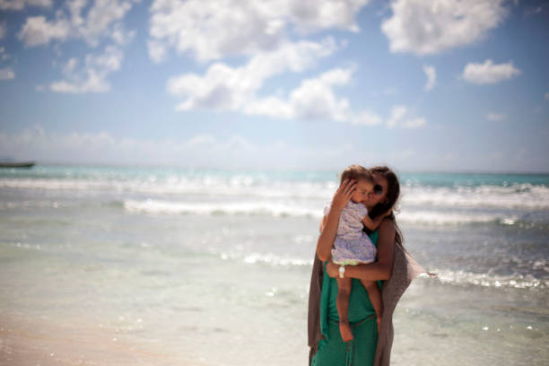 Mother with baby at tropical beach