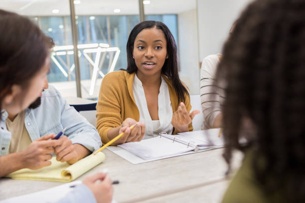 istock Young woman shares ideas during college study group 1132123693