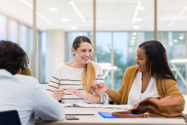 istock Female college friends laugh together during study group 1132124032