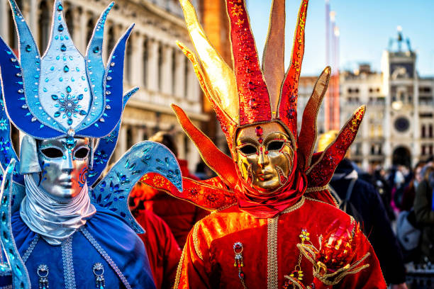 Venetian masked model from the Venice Carnival Close-up of a costume reveller poses during the Carnival in Venice, Italy. gondola traditional boat photos stock pictures, royalty-free photos & images