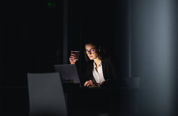 Overworked Businesswoman Working Late in The Office Businesswoman Working Late in The Office working late stock pictures, royalty-free photos & images