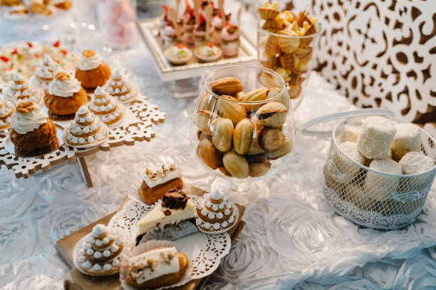 istock Table with muffins, cakes, sweets, candy, buffet. Dessert table for a party goodies for the wedding banquet area. Close up. candy bar. Decorated delicious. 1132126381