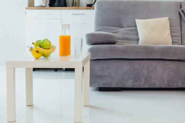 Composition of various home furnishing on white shelf on green wall background