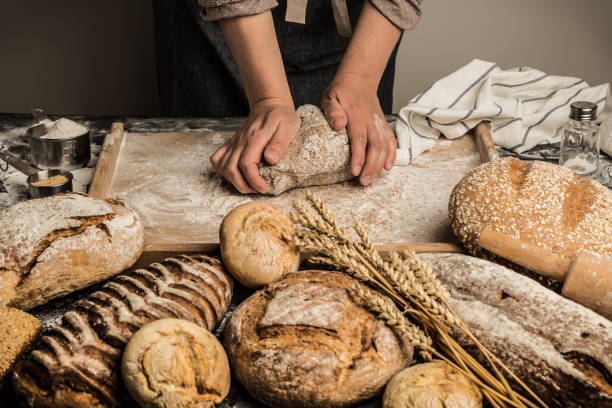 istock Bakery - baker's hands kneading raw dough, making bread 1132128511