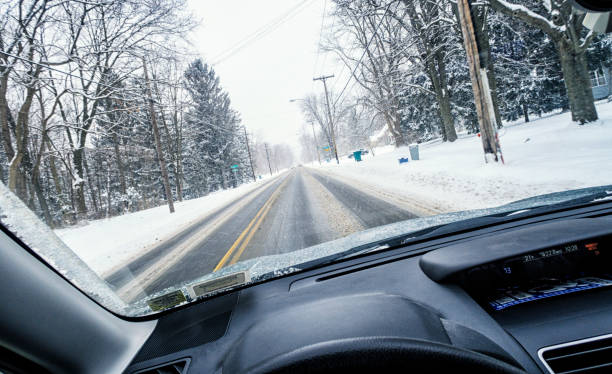 istock Car Driving on Winter Blizzard Rural Road 1132129922