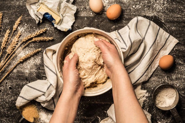 istock Baking - hands kneading the raw dough (pastry) in a bowl 1132130022