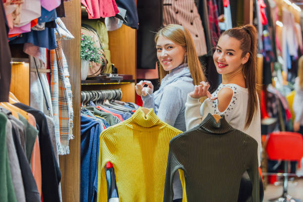istock Two friends choose sweaters during shopping. Feel good, smiling and laughing. 1132130117