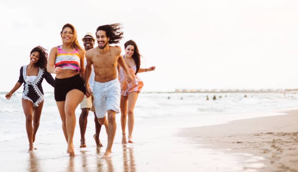istock happiness friend running happiness on the beach 1132130543