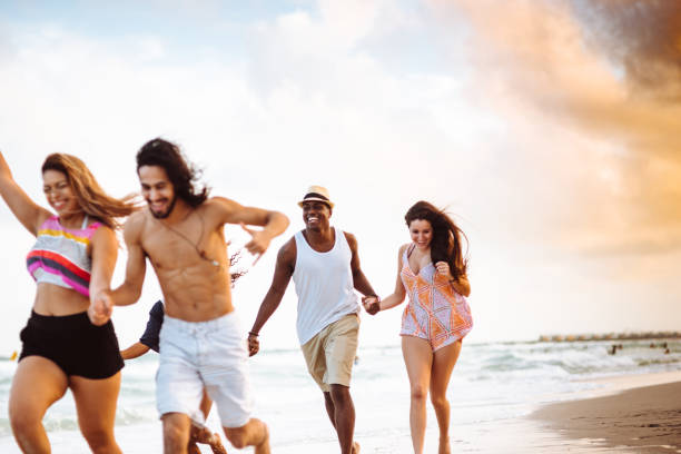 istock happiness friend running happiness on the beach 1132130653