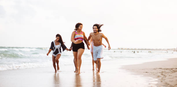 istock happiness friend running happiness on the beach 1132130698