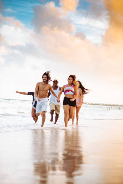 istock happiness friend running happiness on the beach 1132130744