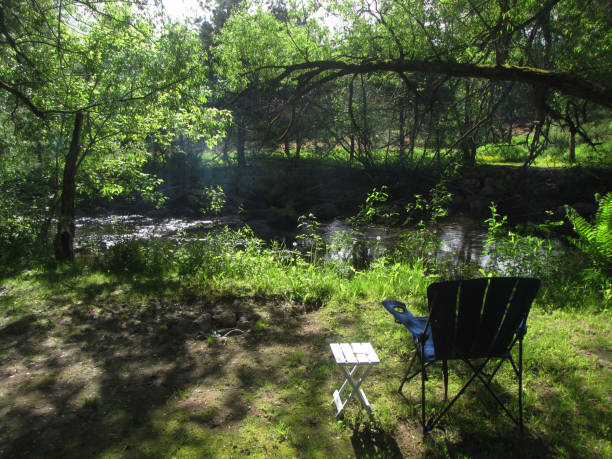 istock Adirondack camping chair overlooking a river, Eastern Townships, Quebec, Canada 1132132973