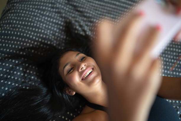 istock Young woman taking selfie with smartphone at home 1132134172