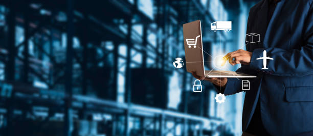 Businessman manager using laptop check orders online goods worldwide for network with Modern Trade warehouse logistics. Industry of logistics network concept.