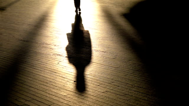 Silhouette unrecognizable person walking in slow motion