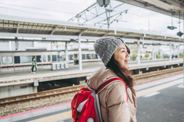 istock backpacker Asian woman and a station 1132139403