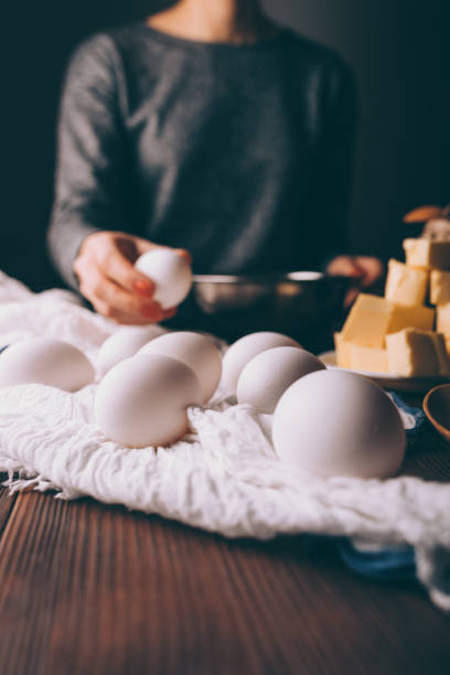 istock Female's hand pick egg to prepare shortcake dough for pie 1132144575
