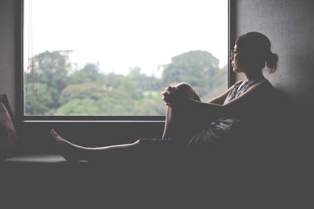 istock woman looking at a window 1132146318