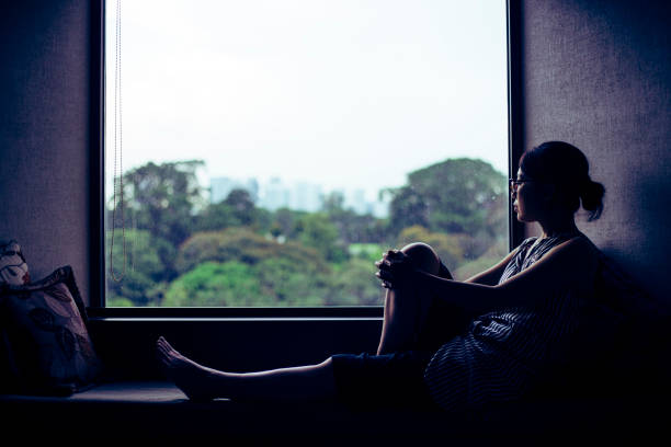 istock woman looking at a window 1132146319